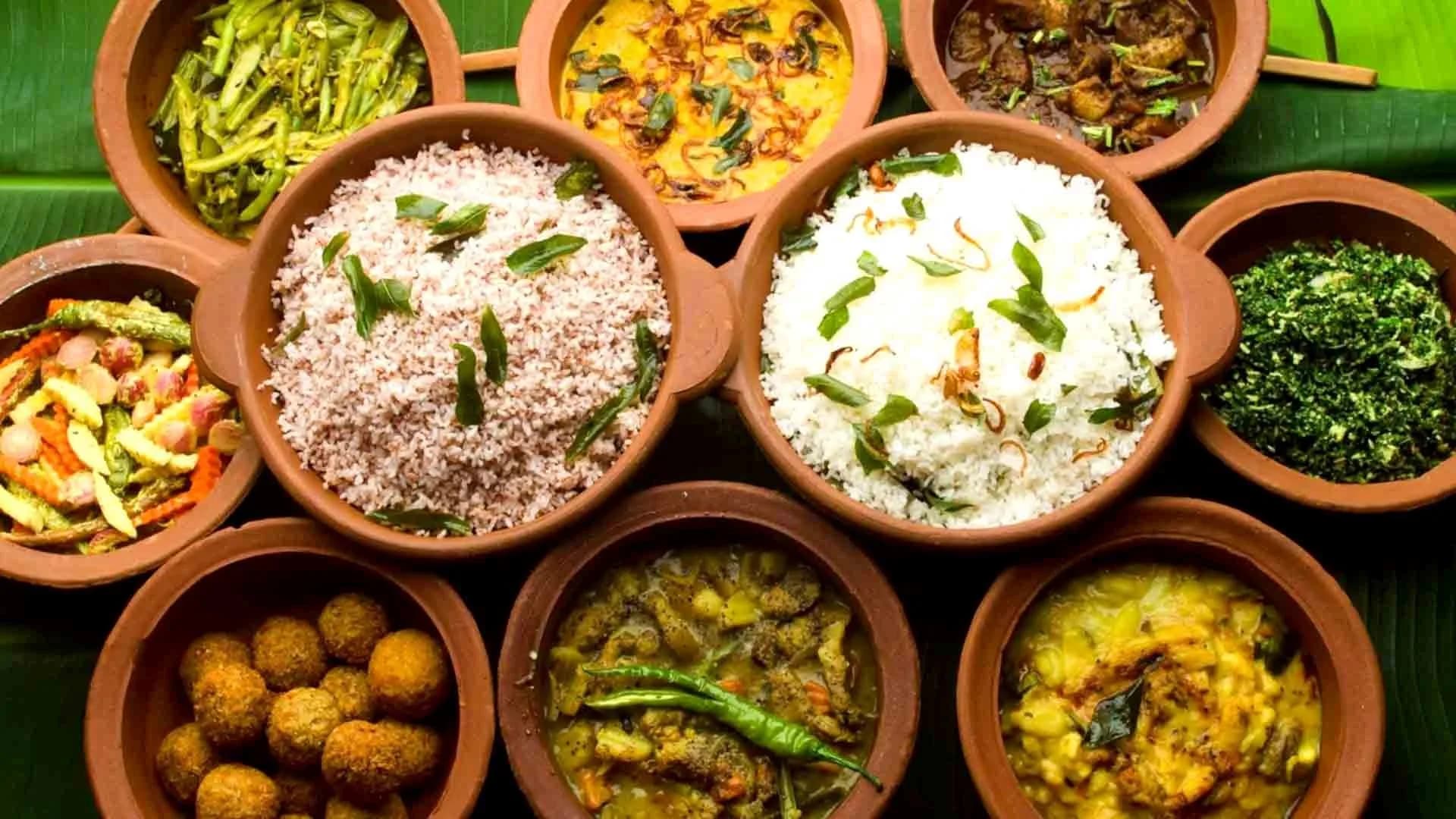 Gorgeous overhead of multiple Sri Lankan curries in clay pots with rice on banana leaf
